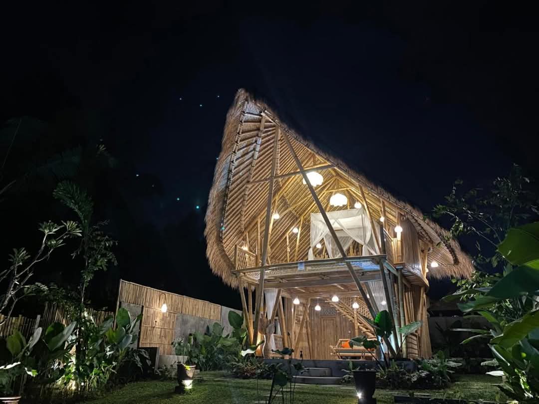 Bamboo villa illuminated at night